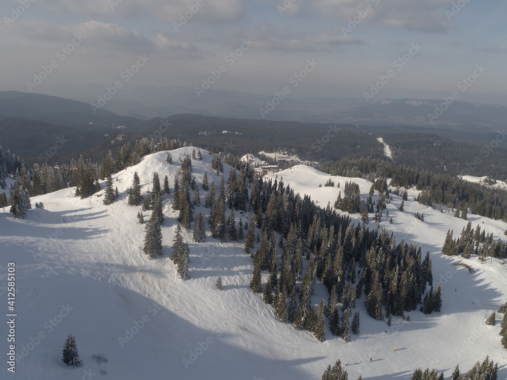 sunny winter day with fresh snow in ski resort