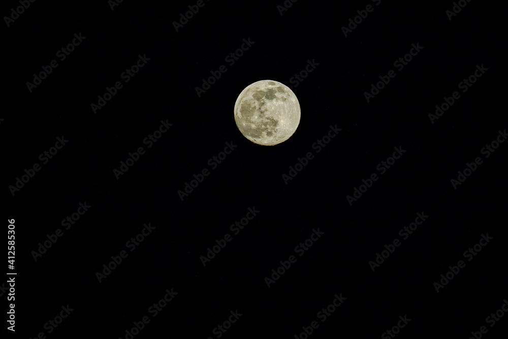 Closeup of full moon. Shining Moon closeup in black background. Soft focus