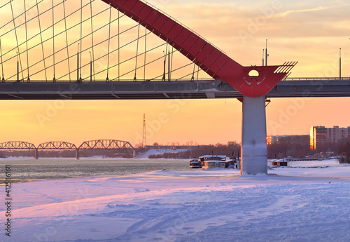 Winter morning on the Ob. Bugrinsky automobile and Komsomolsky railway bridges on the frozen river bank in Novosibirsk photo