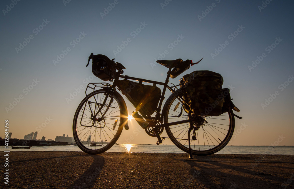 Obraz premium Touring bike parked in the evening at Pattaya Beach, Thailand