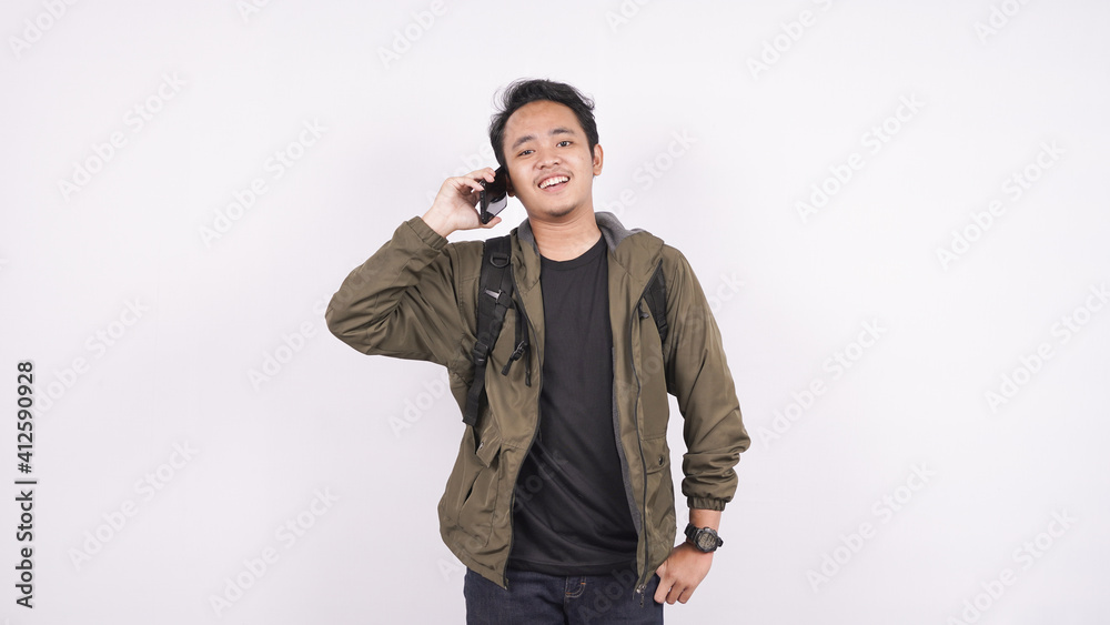 Fototapeta premium Asian man is calling on a white background