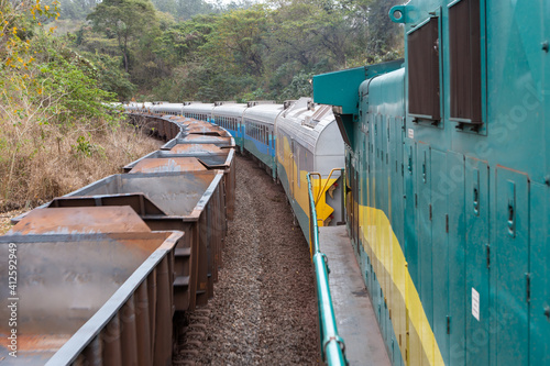 View of iron ore old train from Companhia Vale do Rio Doce running on railroad tracks seen from the locomotive window. Concept of industry, transport, logistics. Maranhão state , Brazil. photo