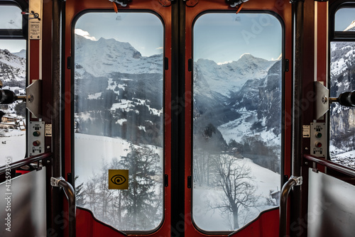 Wengernalp Railway in winter . Train to wengen in jungfrau region in the canton of Bern in  Swiss Switzerland photo