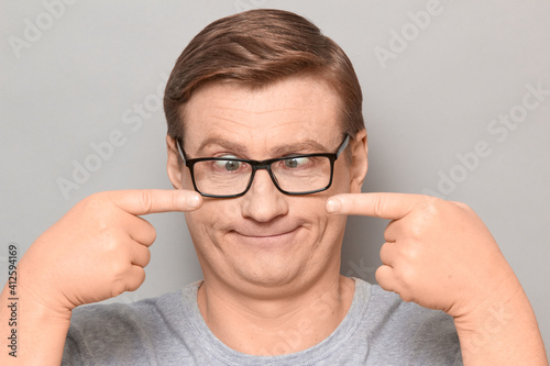 Portrait of funny man fooling around and making goofy silly face