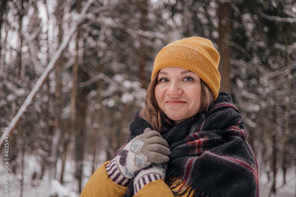 Young Cheerful woman spending time in winter snowy forest. Having fun in winter holidays Young Cheerful woman spending time in winter snowy forest. Having fun in winter holidays