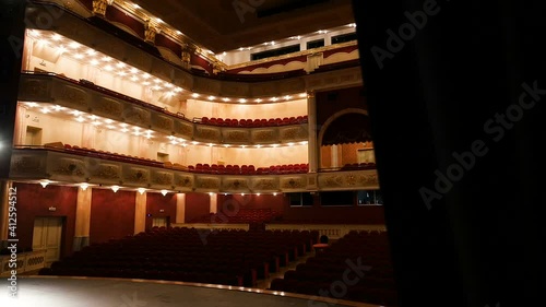 Opening view of the glowing concert hall of the theater from the backstage. Large concert hall. Backstage, curtains