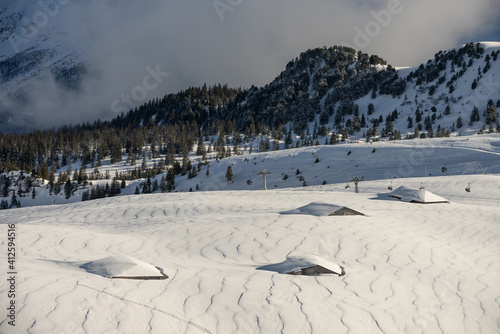 View of the Swiss mountains in winter. Mittelhornin clouds, Schreckhorn and Wetterhorn. Swiss alps in Switzerland Jungfrauregion photo