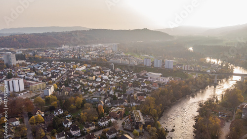 Drone view of cityscape Brugg south-west with Aare river, residential and commercial districts, historic old town and Umiken in canton Aargau in Switzerland. Town situated on feet of Tafeljura. photo