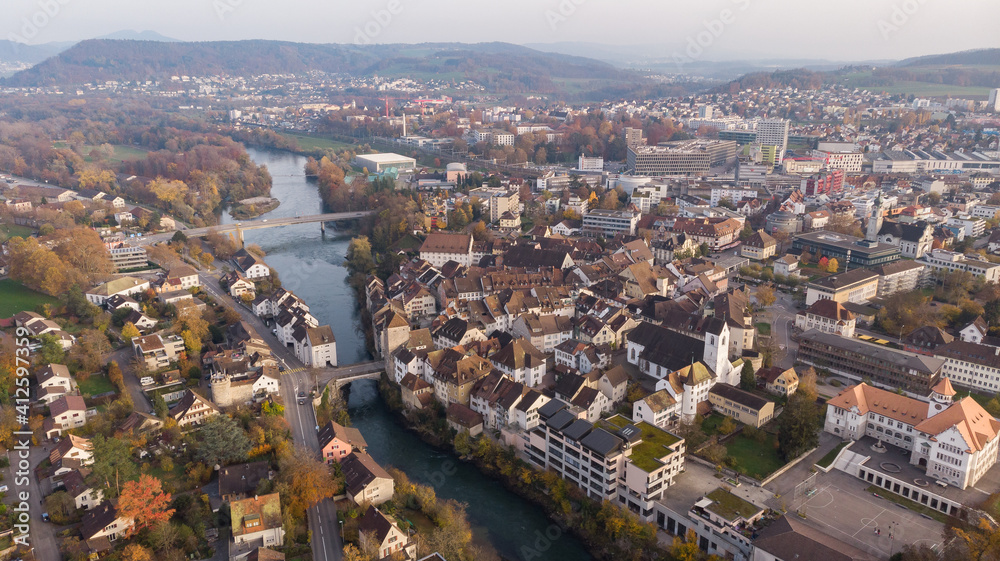 Drone view of cityscape Brugg north-east with Aare river, residential and commercial districts, historic old town and casino bridge in canton Aargau in Switzerland. Town situated on feet of Tafeljura.