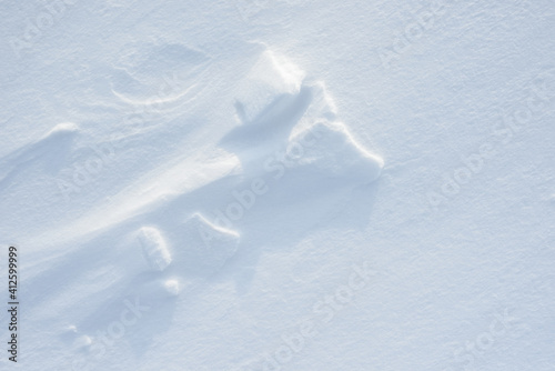 Fresh clean white snow background texture. Winter background with snowflakes and snow mounds. Snow lumps. Seasonal landscape details.