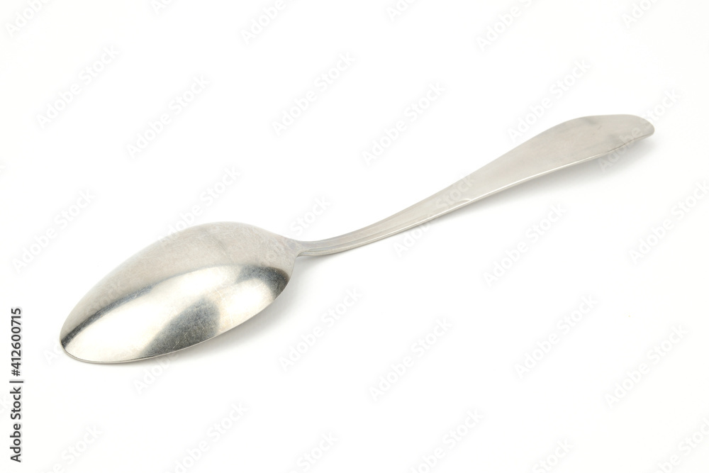 A tablespoon lying on the diagonal of the image, bottom up. A tablespoon lying on the diagonal of the image, bottom up.