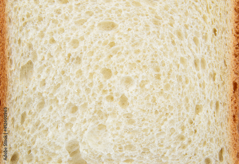 Close-up of a piece of white wheat bread with brown crusts around the edges