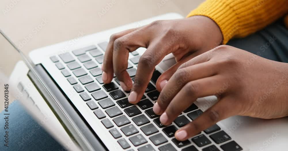 Hands of woman typing on keyboard of laptop