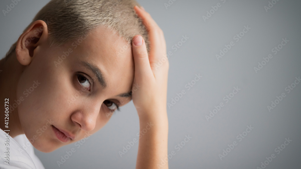 Portrait of pensive young woman with short hair on white background. Copy space Portrait of pensive young woman with short hair on white background. Copy space