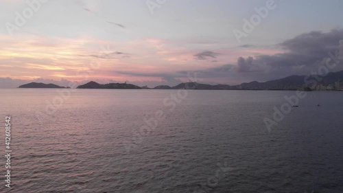 Beautiful view of the beach, aerial view of the beach, acapulco beach seen from above. Travel and vacation concept. Colorful sunset on the beach. Aerial video