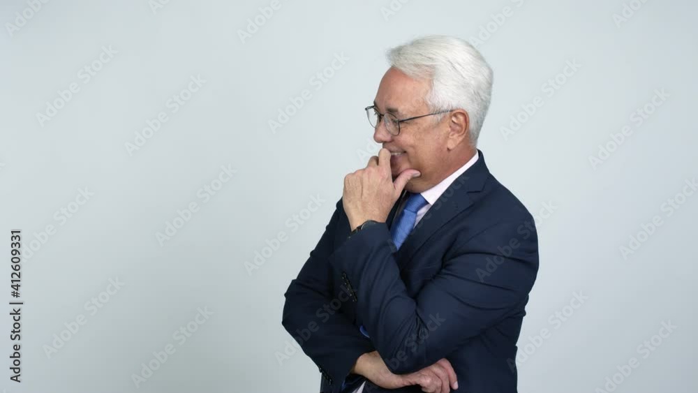 Middle age businessman standing and looking to the side over isolated background Middle age businessman standing and looking to the side over isolated background
