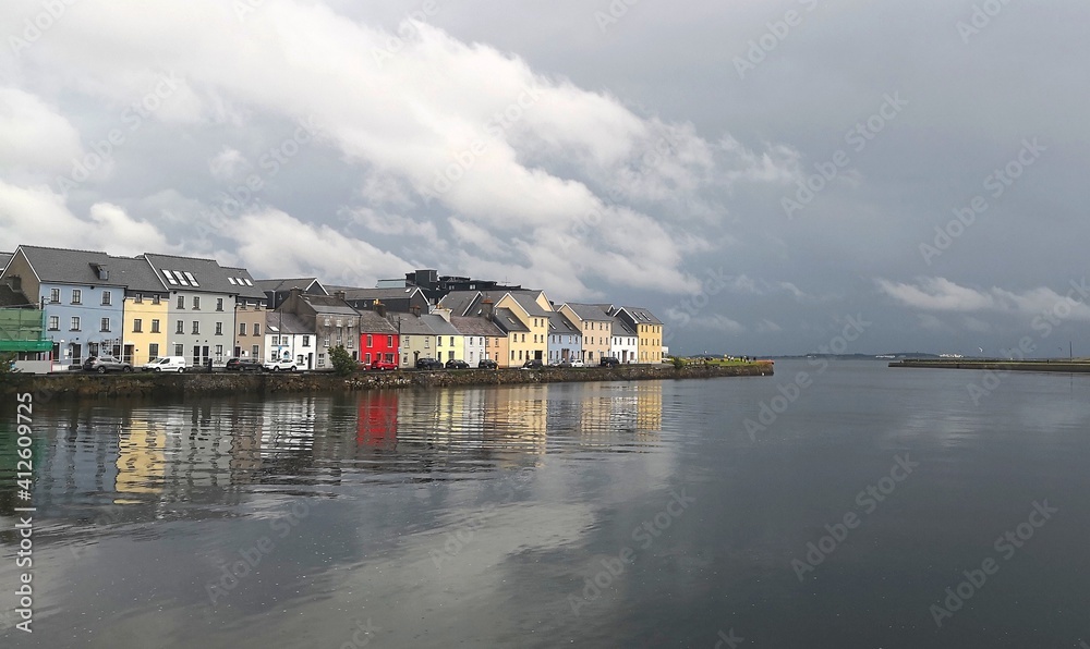Colourful houses by the ocean in Galway, Ireland ona a cloudy day