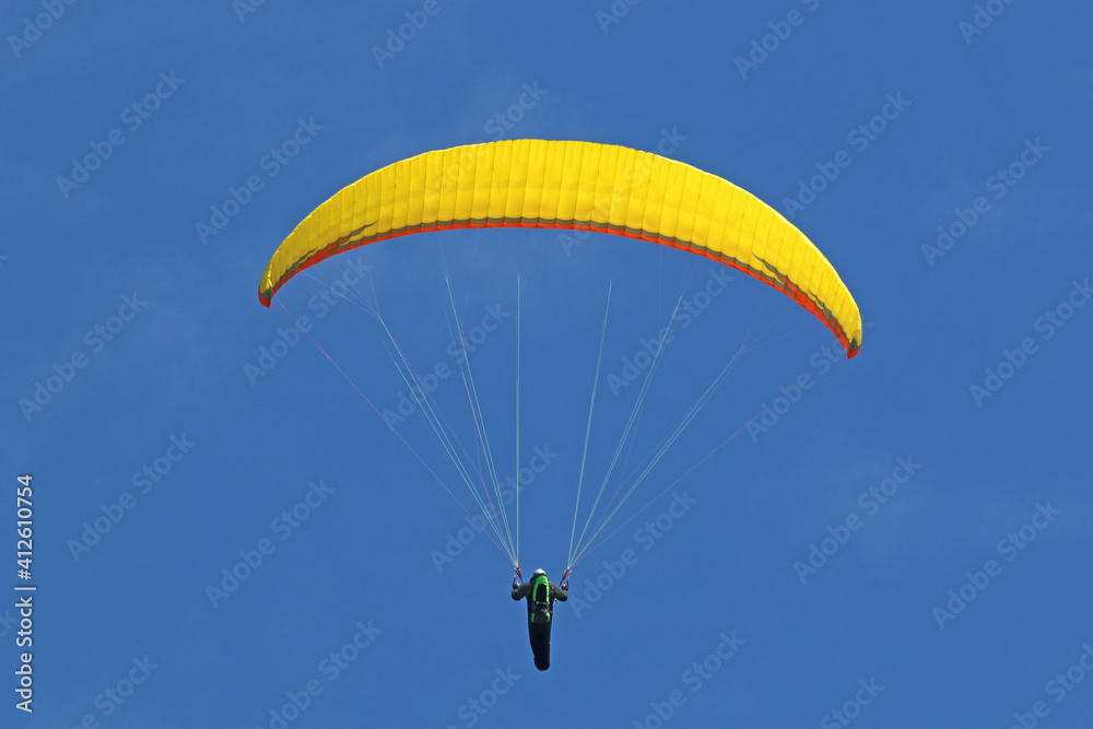 Paraglider flying wing in a blue sky Paraglider flying wing in a blue sky