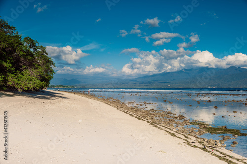 Holiday beach and ocean at low tide in tropics.