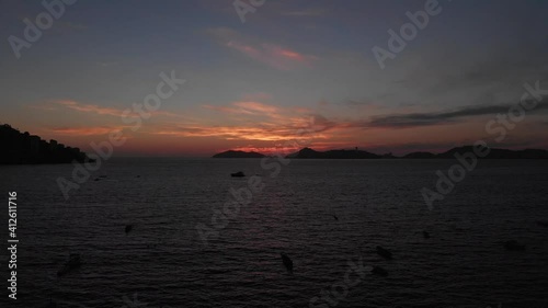 Beautiful view of the beach, aerial view of the beach, acapulco beach seen from above. Travel and vacation concept. Colorful sunset on the beach. Aerial video