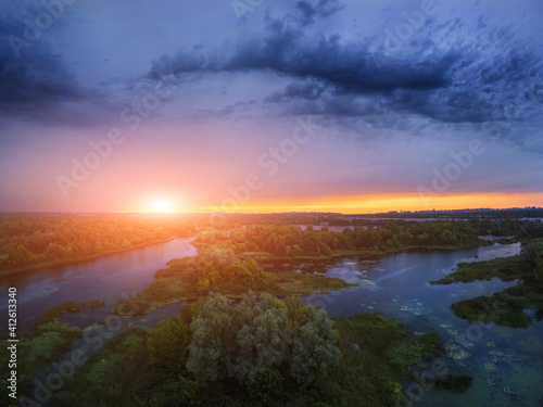 amazing spring (summer) landscape. aerial view of green forest and blue river. drone shot forest and river at sunset. drone shot