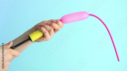 woman hand using air pump inflate balloon close up photo