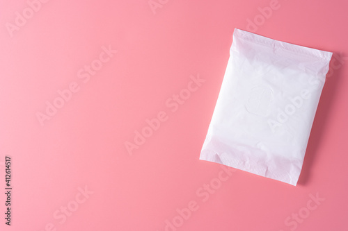 Sanitary pad, Sanitary napkin on pink background. Menstruation, Feminine hygiene, top view.