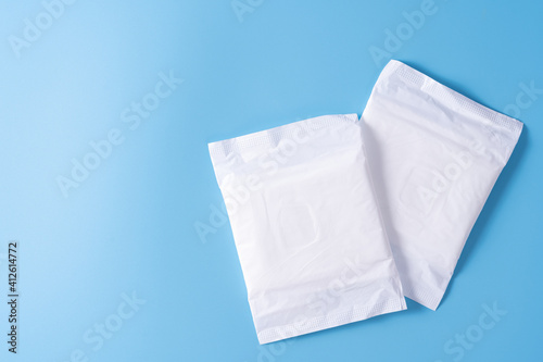 Sanitary pad, Sanitary napkin on blue background. Menstruation, Feminine hygiene, top view.