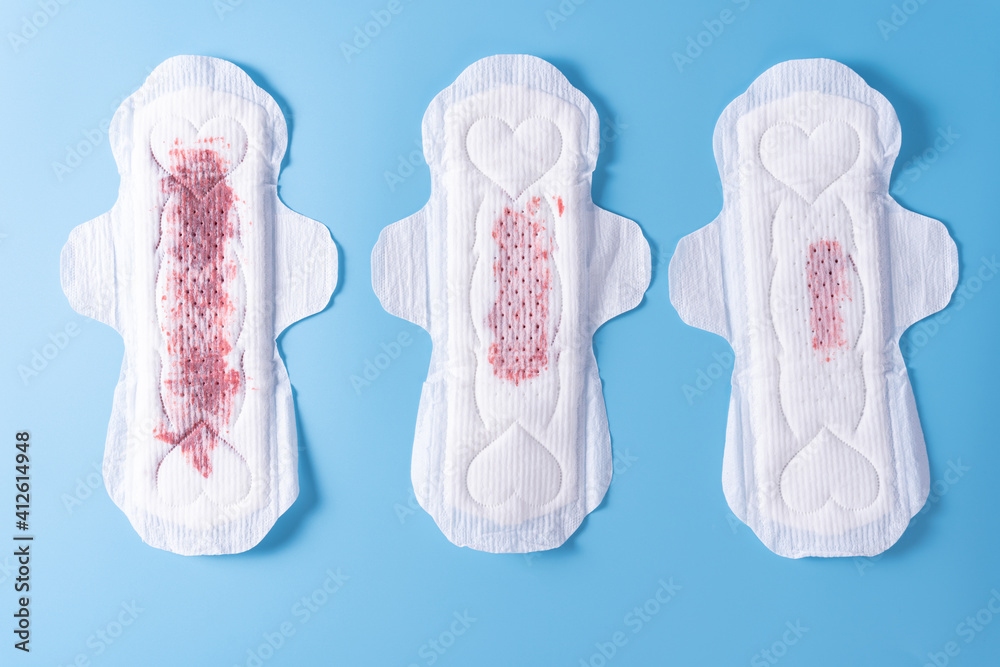 Set of different used sanitary pad, Sanitary napkin on blue background. Menstruation, Feminine hygiene, top view. Set of different used sanitary pad, Sanitary napkin on blue background. Menstruation, Feminine hygiene, top view.
