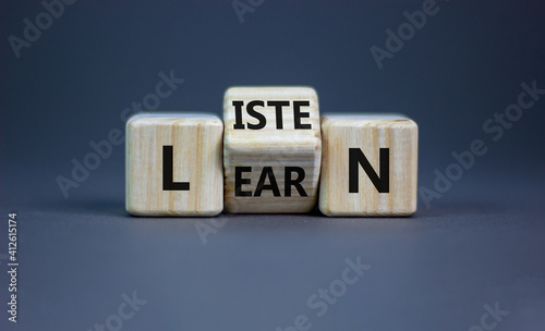 Listen and learn symbol. Turned a wooden cube and changed the word 'listen' to 'learn'. Beautiful grey background, copy space. Business, education and listen and learn concept. photo