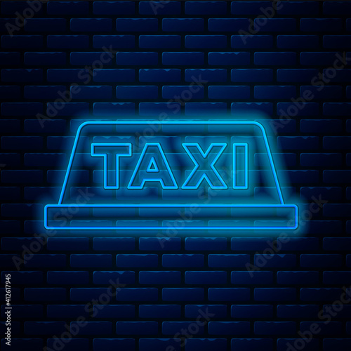 Glowing neon line Taxi car roof icon isolated on brick wall background. Vector.