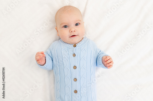 portrait of a baby boy on the bed. Happy smiling baby