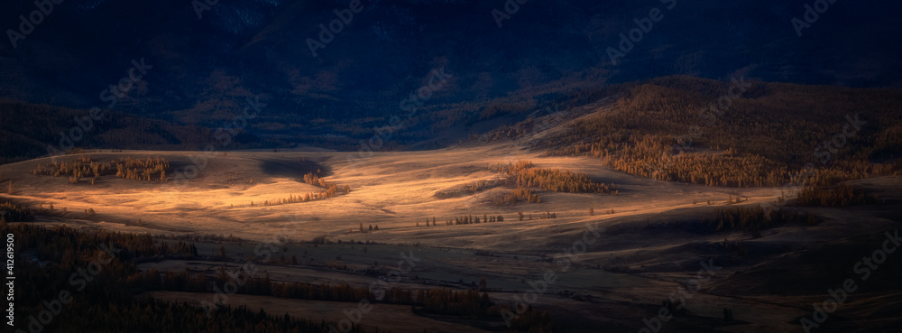 dawn ray of light in the Kurai steppe, Chui ridge, Altai Mountain in autumn, Russia