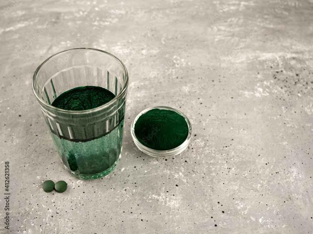 Spirulina algae in a glass of water .a superfood that contains proteins, fats, carbohydrates, and vitamins. Spirulina algae in a glass of water .a superfood that contains proteins, fats, carbohydrates, and vitamins.