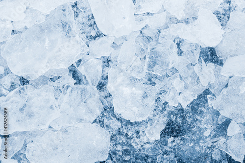 Ice pieces texture background. Crushed ice blue toned pattern.