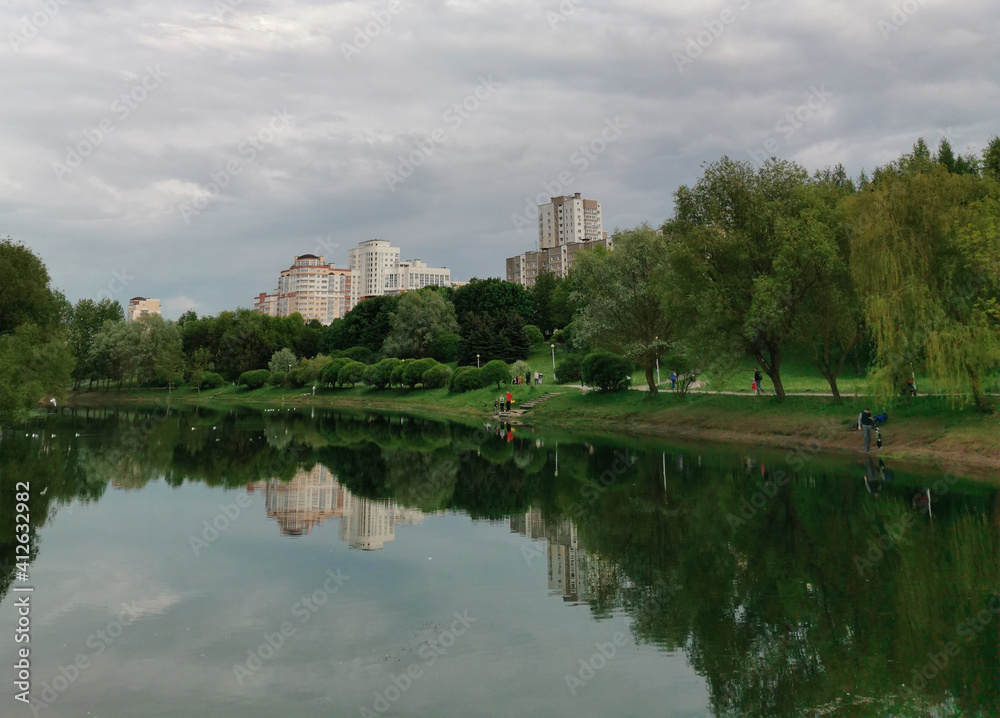 Nice view of the lake and park in the city in summer