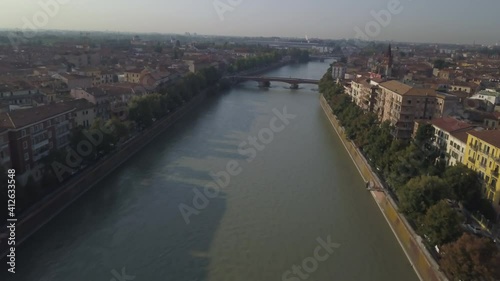 Wallpaper Mural Panoramic evening aerial view of Verona ancient city. The drone approaches the river Adige, the typical Italian apartment rooftops and bridge Ponte Pietra. Video in 4K Torontodigital.ca