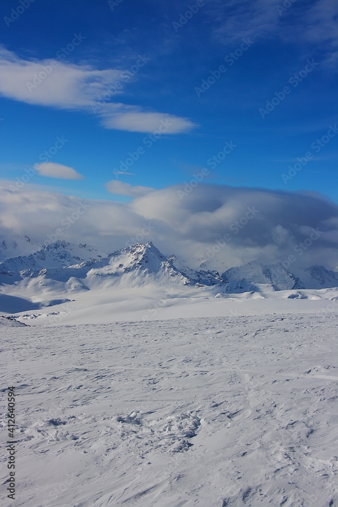 Winter landscape of the mountains of the North Caucasus in the snow with clouds.