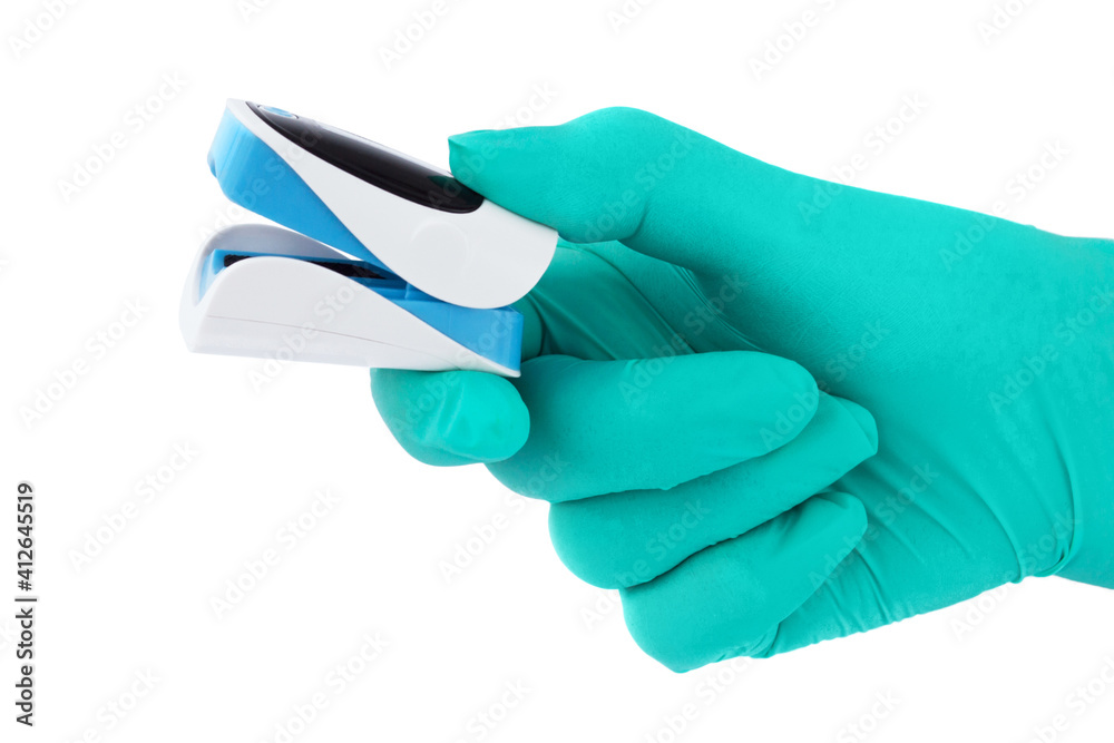 A doctor's hand in a thin green glove holds an oximeter to check oxygen saturation. Medical equipment for measuring pulse rate and blood oxygen level. Isolated on white background. A doctor's hand in a thin green glove holds an oximeter to check oxygen saturation. Medical equipment for measuring pulse rate and blood oxygen level. Isolated on white background.