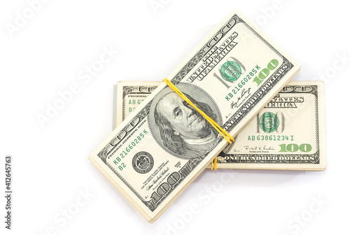 two bundles of one hundred dollar bills tied with an elastic band, isolated on a white background.
