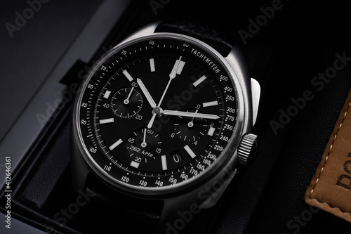 Black luxury watch on black background