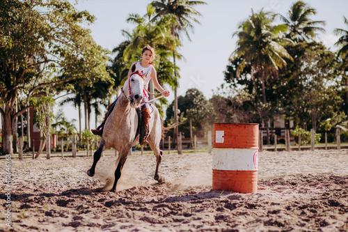 little girl running barrels on horse back 