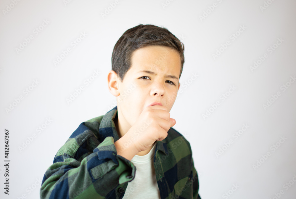 Young boy with pain gesture over white background. Young boy with pain gesture over white background.