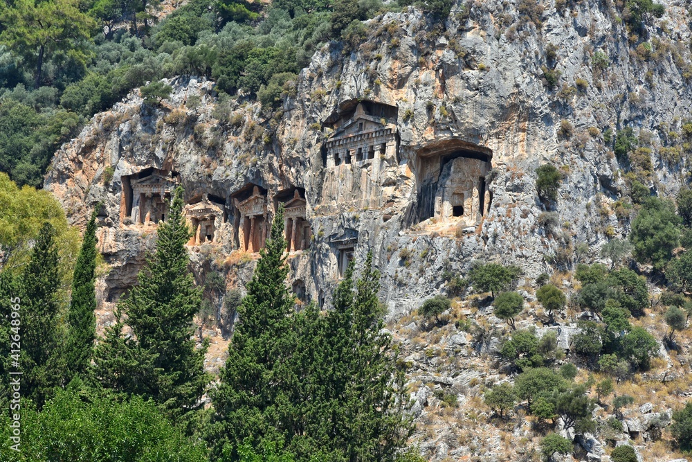 Amazing view of the Lycian tombs carved into the rock on the Dalyan River, ancient Caunos town, Turkey, Mugla. Turkish famous historical landmark