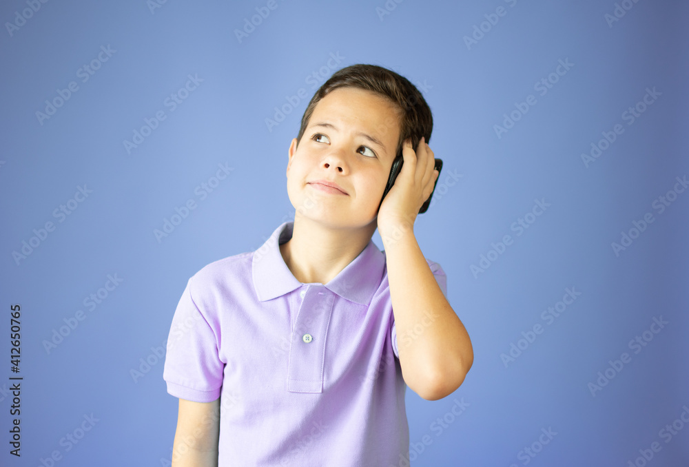 Beautiful young boy smiling talking on the phone Beautiful young boy smiling talking on the phone