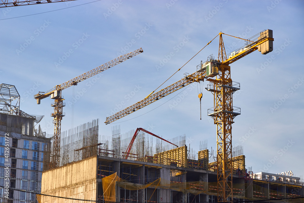 tower cranes on the construction site of multi-storey residential buildings tower cranes on the construction site of multi-storey residential buildings