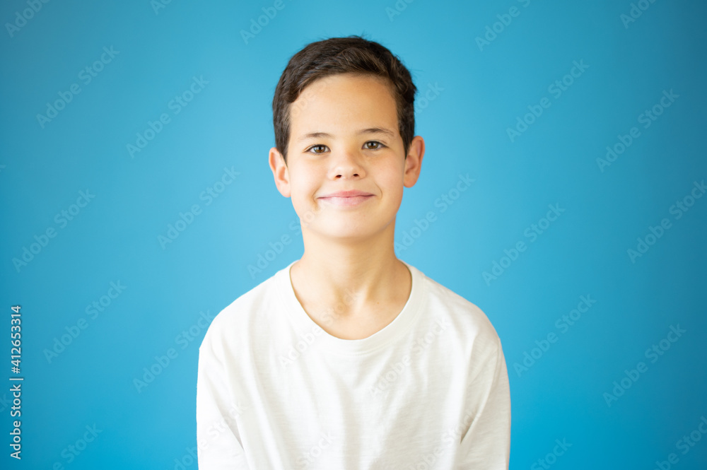 Portrait of happy young boy confident boy standing isolated on blue Portrait of happy young boy confident boy standing isolated on blue