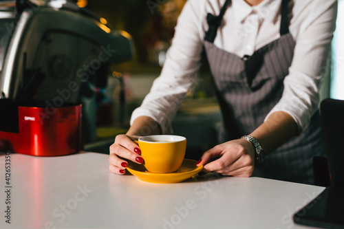 waitress preparing espresso coffee in cafeteria