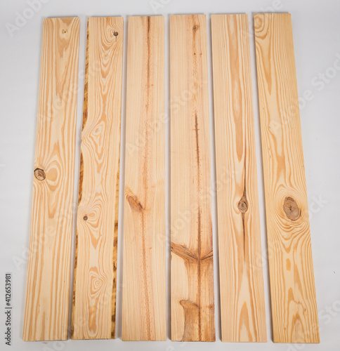 Unfinished raw pine lumber on a solid white background photo