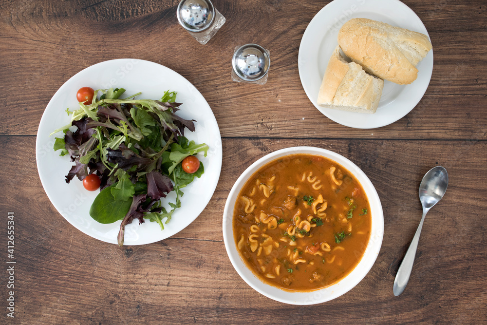 Soup and Salad with room for copy on a Wooden Table Soup and Salad with room for copy on a Wooden Table